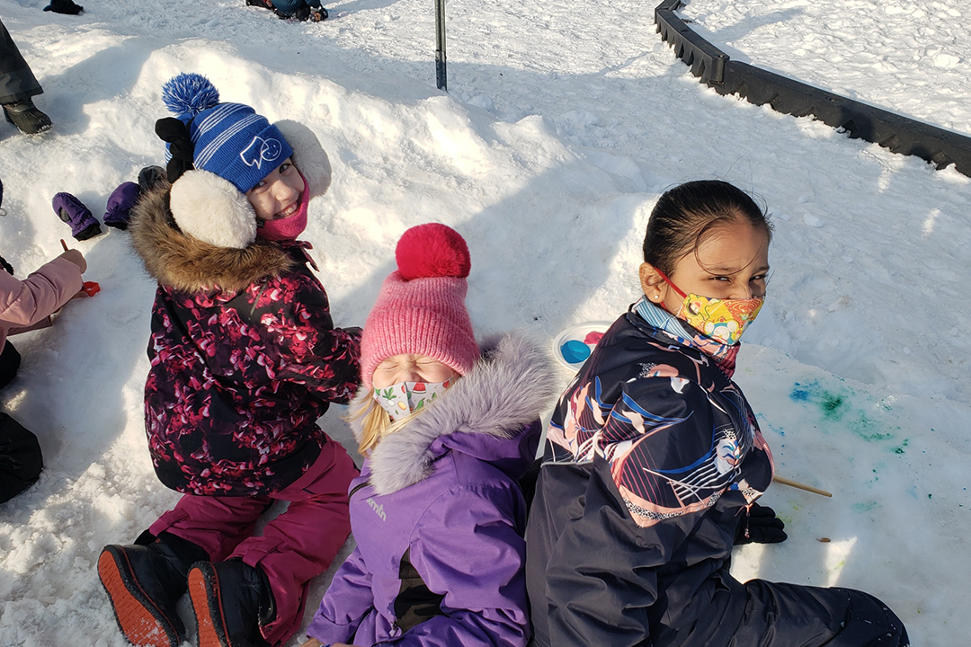Three girls play in the snow at a PLASP Winter Holiday program