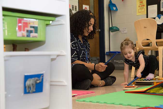 A child with PLASP EarlyON staff