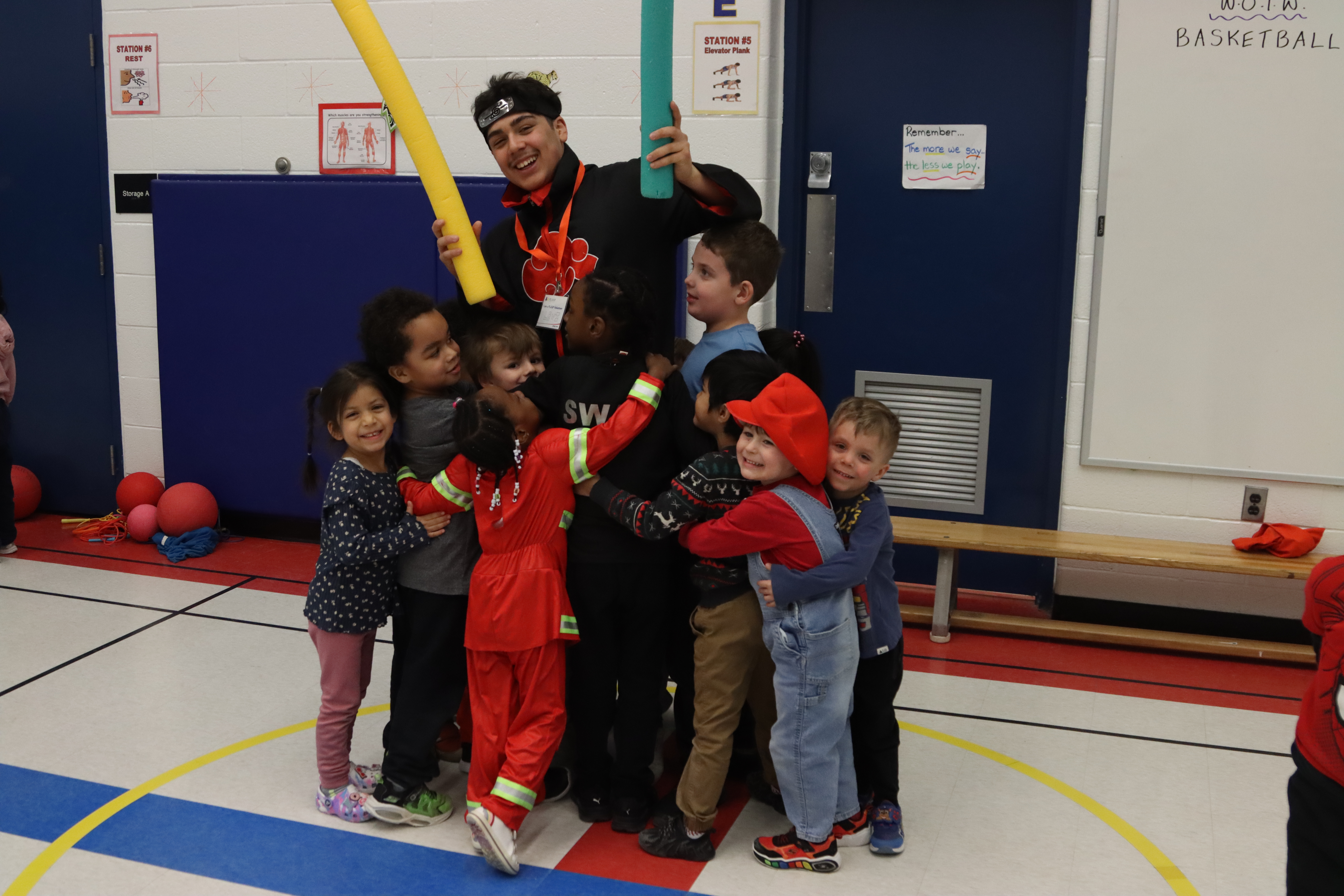 A volunteer has fun with a group of PLASP children