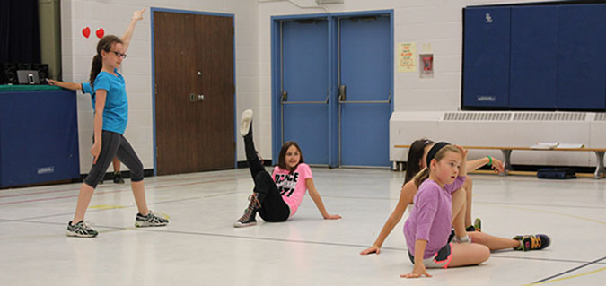 Four girls practicing disco moves