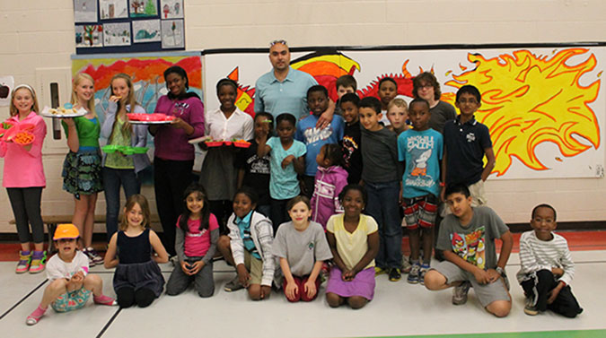 A group photo of parents, children and their artwork