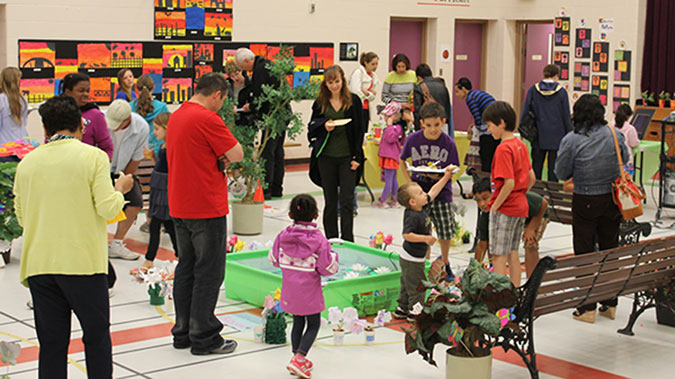 Parents, children and staff explore artwork on display