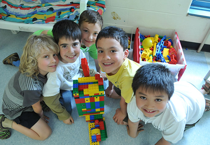 Five boys show off their Lego creation