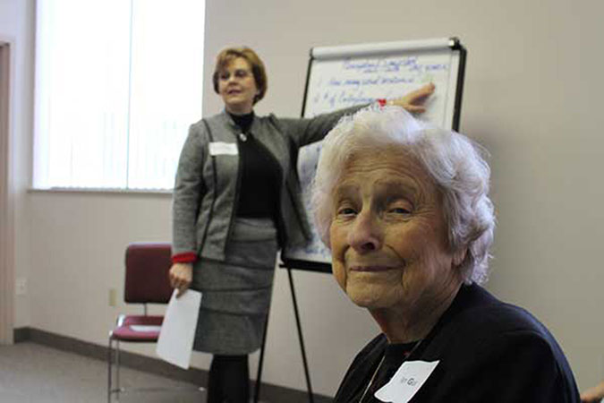Fern with Vice President Sandy Edmonds speaking in the background
