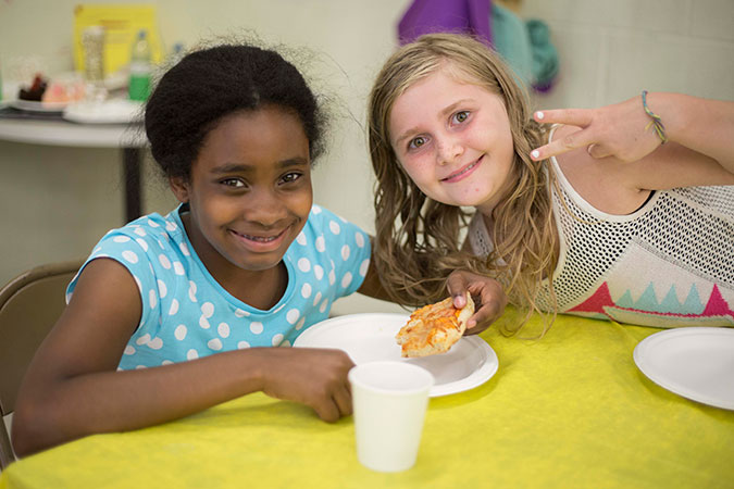 Two girls at mealtime