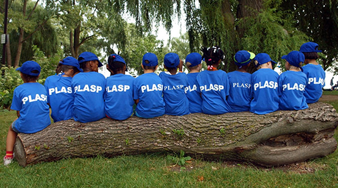 A group of children sitting on a log