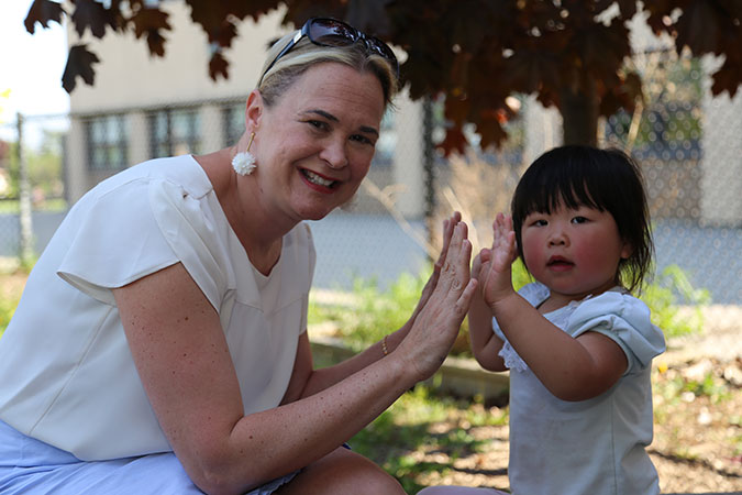 PLASP staff giving a child a high five