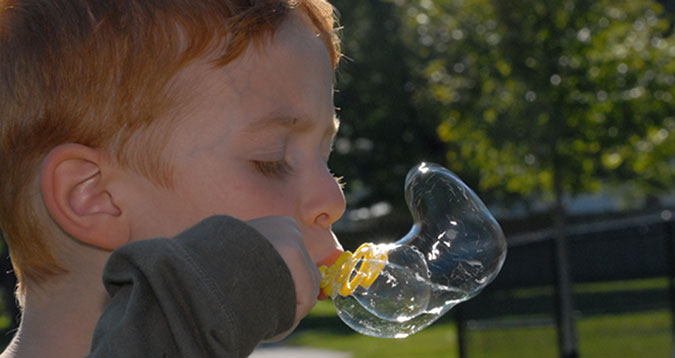 A child blows bubbles