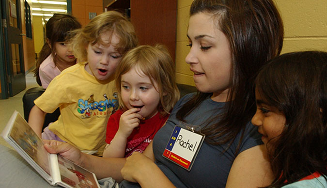 A PLASP volunteer with four children