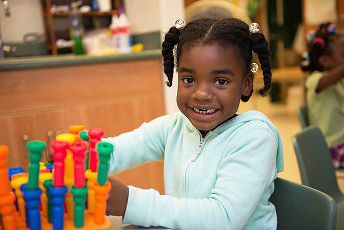 A child plays with coloured building toys