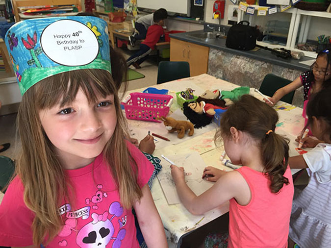 A girl wearing a handmade paper crown
