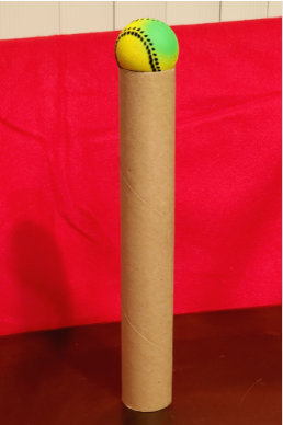 Ball balanced on top of a cardboard tube