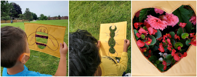 Children holding paper cutouts outside