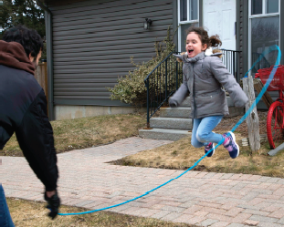 Child jumping over skipping rope