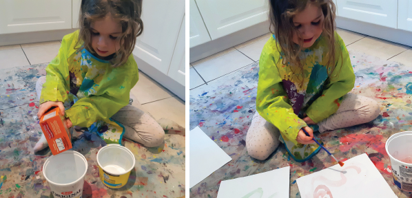 Girl pouring baking soda into container to make paint