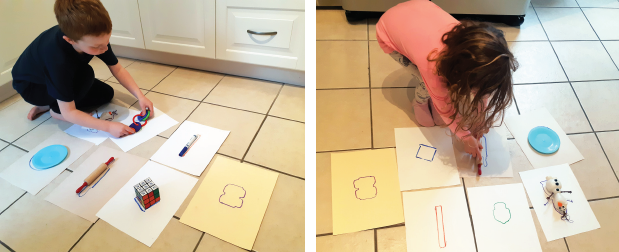 Children placing objects on outlines drawn on paper